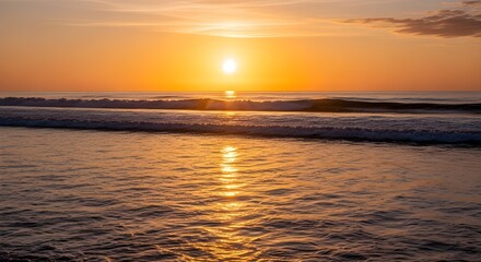 Brilliant golden hour sunset over the vast ocean horizon, creating a spectacular reflection of the bright sun on the gentle sea waves.