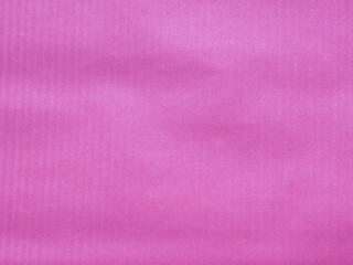 Fototapeta premium Pink paper with vertical lines, red background. Idea for design, text, Valentine's Day.