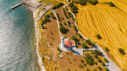 Seddulbahir, Eceabat, Turkey. Historic Mehmetcik Feneri lighthouse standing at entrance to Dardanelles Strait with panoramic view of Aegean Sea coastline. Aerial drone view.. Aerial View