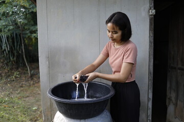 Woman doing laundry in the morning.