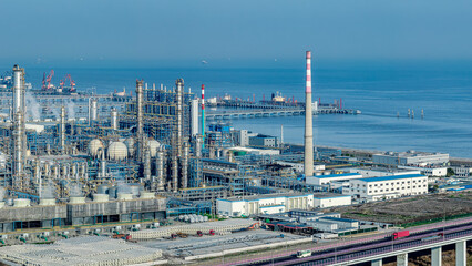 Complex pipeline equipment in chemical factory plant near the sea coast.