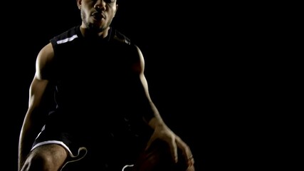 Close video of Basketball players legs during the game practice. Basketball player dribbling ball on indoor court. man training in dribbling basketball. - Powered by Adobe