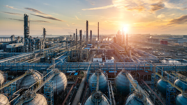 Oil refinery and chemical plant industrial area at beautiful sunset.