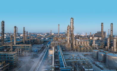 Exterior shot of large petrochemical industrial complex with distillation towers and pipes. © zhao dongfang