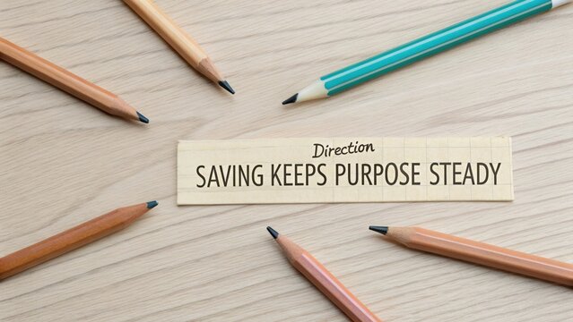 Creative Workspace Arrangement with Pencils and Inspirational Message about Saving and Purpose on Light Wooden Surface