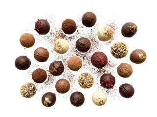 Delightful Assortment of Artisan Chocolates Presented on a Rustic Tabletop Surrounded by Cocoa Powder and Nuts