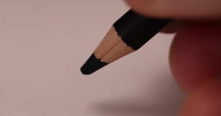 drawing with a black pencil on paper , drawing on paper with a pencil with a black lead, the word love written in black pencil on paper - Powered by Adobe