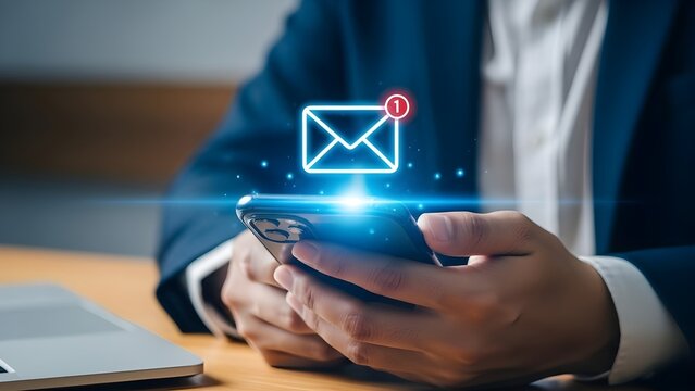 Businessman receiving new email notification on smartphone with digital envelope icon overlay for communication