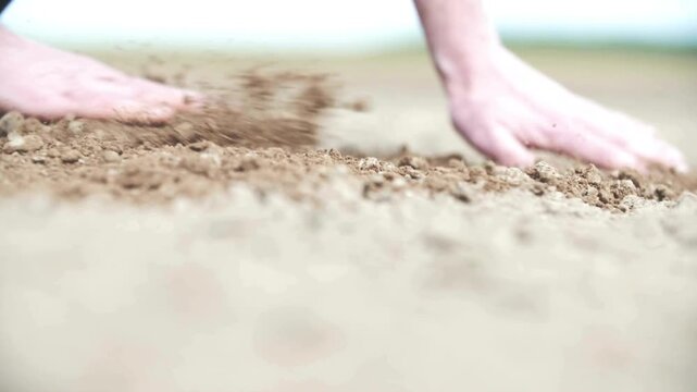 Mature man's hand in soil on agricultural land. arable soil in hands of responsible farmer, close up. farmer's hand on the ground to examining soil quality and fertility.