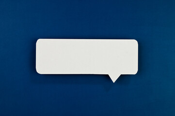 White speech bubble on blue background.