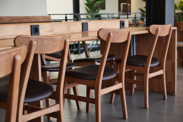 Modern wooden chairs at a cozy cafe setting