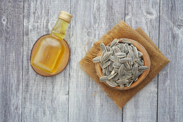 Sunflower seeds and oil on rustic wooden table