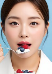 Radiant Beauty Savoring a Perfect Spoonful of Fresh Berries and Yogurt.
