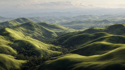 Aerial view of rolling green hills and valleys under a hazy sky on a sunny day outdoors