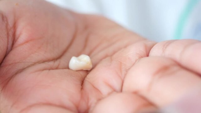Child proudly displays lost baby tooth during school time