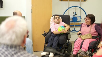 Young man with physical disability playing ball during physiotherapy session