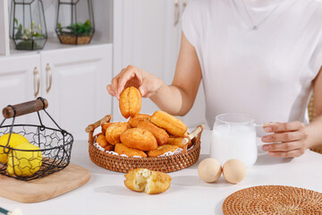 Traditional Golden Doughnuts in Wicker Basket - Homemade Delicious Crispy Snacks with Milk in Modern Kitchen