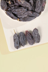 Xinjiang Turpan Black Dried Grapes Raisins in White Bowl Traditional Chinese Fruit