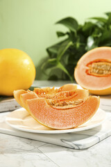 Fresh Honeydew Melon Slices with Yellow Cantaloupe on White Plate - Healthy Summer Fruit Still Life © NguyenThi