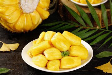 Fresh Vietnamese Jackfruit Segments on White Plate with Palm Leaves - Golden Tropical Fruit