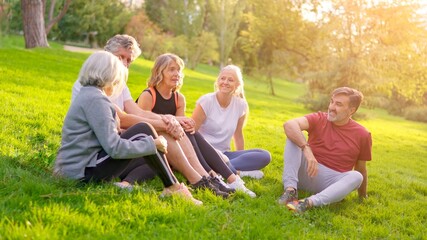 Fototapeta premium Senior friends talking together after training in the park