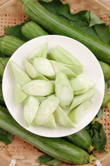Fresh Shouguang Loofah Vegetables - Sliced Green Produce in Bamboo Basket