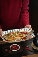 Braised Whole Fish with Fresh Herbs and Spices - Traditional Asian Cuisine Presentation