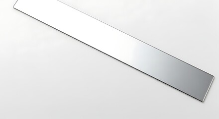 A long, narrow, rectangular piece of shiny metal on a white surface.