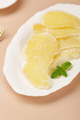 Candied Ginger Slices with Mint on White Plate - Traditional Sweet Preserve