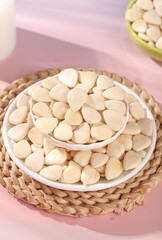 Fresh Blanched Almonds in White Bowls on Pink Background - Healthy Nuts and Cooking Ingredients