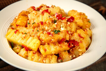 Spiced Potato Dish with Red Peppers and Herbs in White Bowl - Traditional Comfort Food Recipe