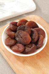 Xinjiang Dried Apricots in White Bowl on Wooden Board - Healthy Snack Food Photography