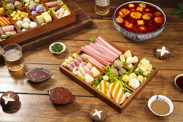Asian Hot Pot Shabu Shabu Ingredients with Spicy Broth and Meatballs on Wooden Table