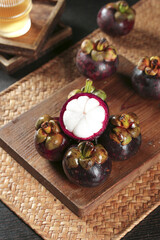 Fresh Mangosteen Fruit from Thailand on Wooden Board - Exotic Tropical Asian Fruit Display