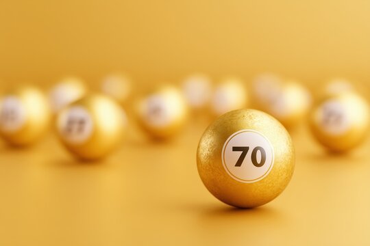 gold lottery balls on yellow background great for celebrating the 70th anniversary or birthday
