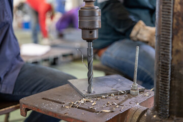 Metal drilling on industrial drill press