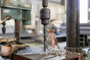 Metal drilling on industrial drill press