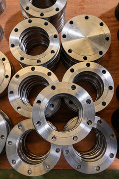 Stacked metal flanges in industrial workshop