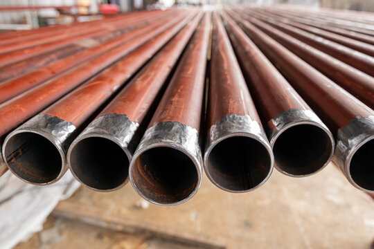 Stack of metal pipes with beveled ends