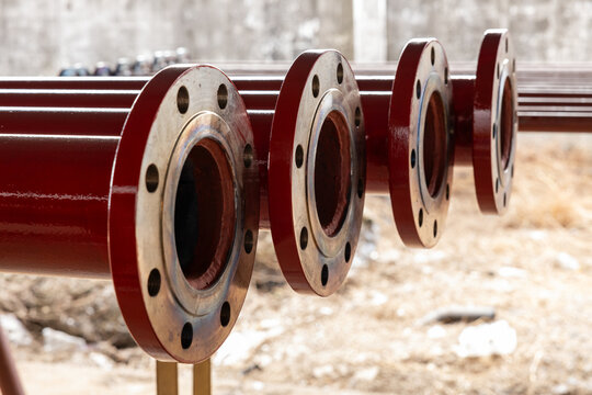 Stack of metal pipes with beveled ends