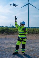 Obraz premium Engineers using drone to inspect wind farm
