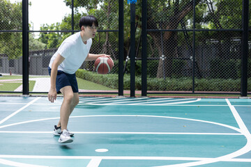 Fototapeta premium Focused Basketball Player Dribbling on Court