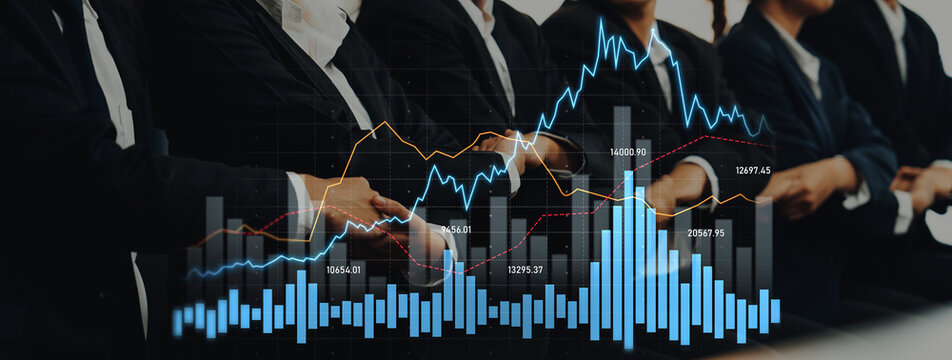 A group of business professionals focuses on stock market trends, analyzing financial graphs and charts in a modern office setting, representing collaboration and strategic planning. Scalp - Powered by Adobe