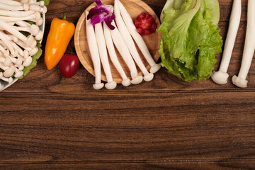 Fresh Hot Pot Ingredients with Mushrooms and Vegetables on Wooden Table