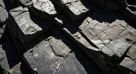 Jagged Dark Basalt Rock Formation with Geometric Patterns and Shadows
