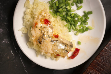 Fish Head with Chopped Vegetables and Peppers on White Plate