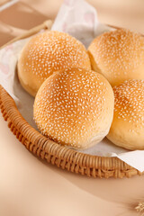 Fresh Sesame Seed Hamburger Buns in Wicker Basket for Commercial Food Service and Burger Making