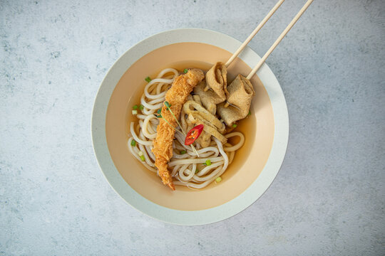 Delicious Udon Noodles with Crispy Tempura Shrimp and Fish Cakes - Powered by Adobe