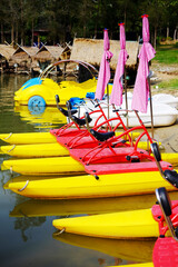 Colorful pedal boats or water bikes and bicycles on kayak for rental in river in Thailand