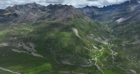 Beautiful green grassland and snow capped mountain in Litang county, China - Powered by Adobe